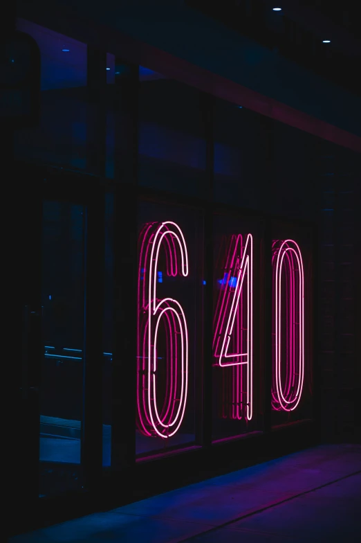 neon light numbers on a window at night