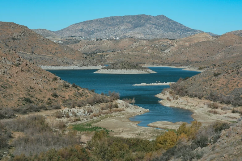 a river is surrounded by several large hills