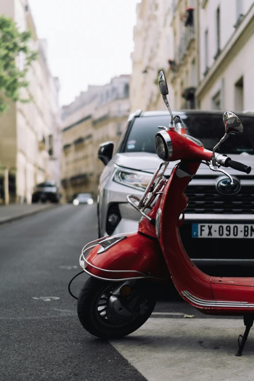 a moped sitting on the side of the road