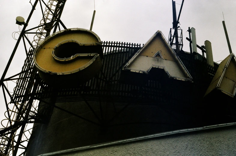 a set of antennas and signs near the top of a structure