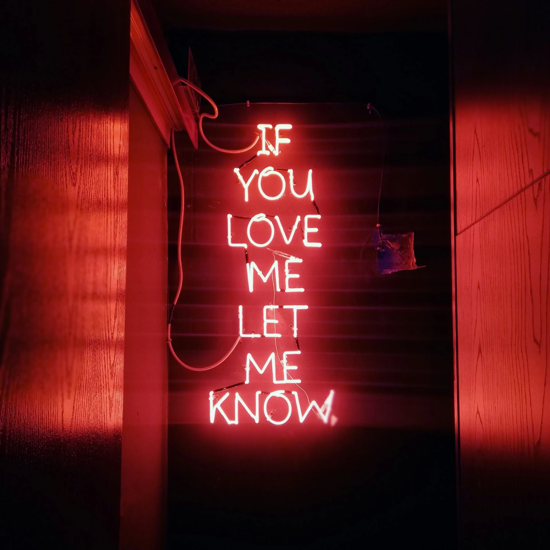 a red neon sign on the side of a building