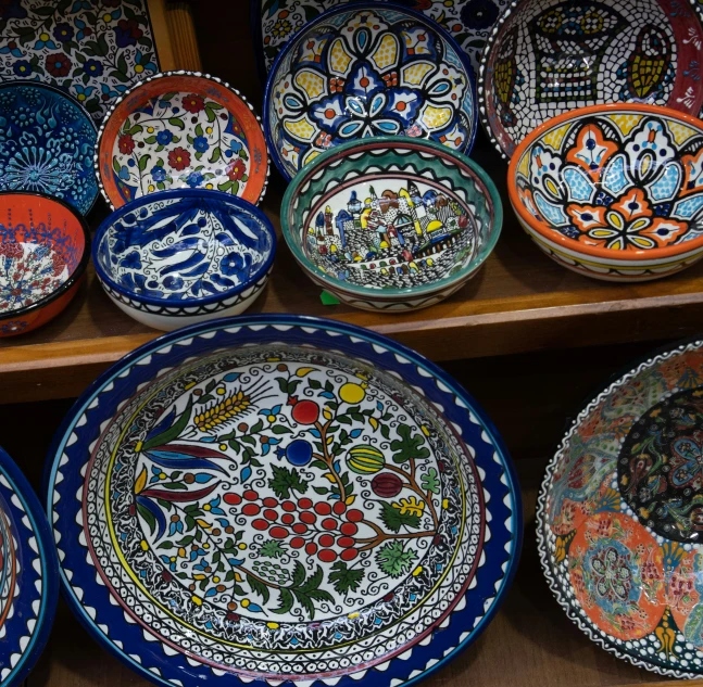 large collection of painted and handpainted ceramic dishes