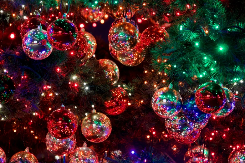 several christmas balls that are hung on trees