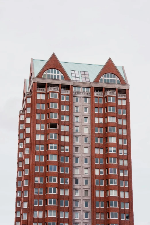 a red building with several windows and a blue roof