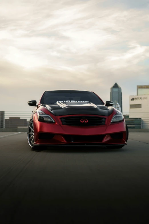 a red sports car driving along the road