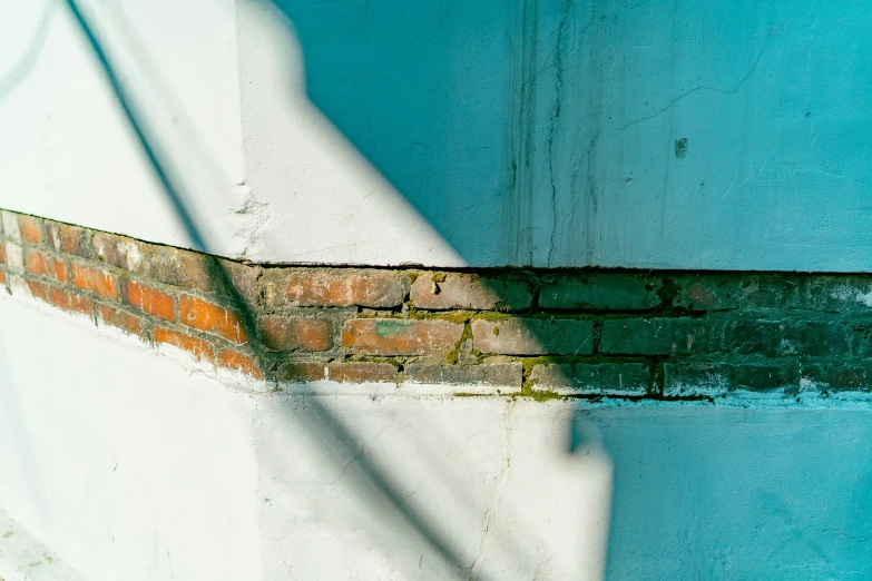 a stop sign and brick wall near a building