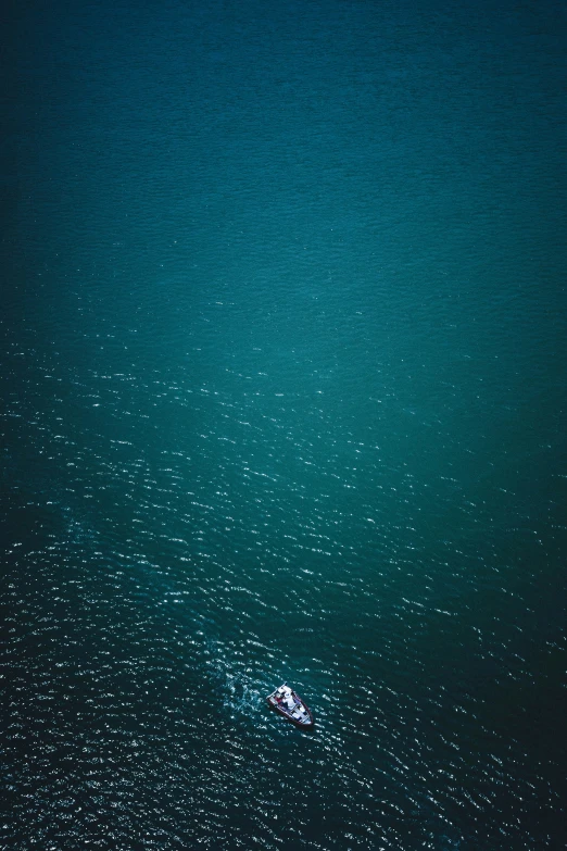 two people in the water under an umbrella