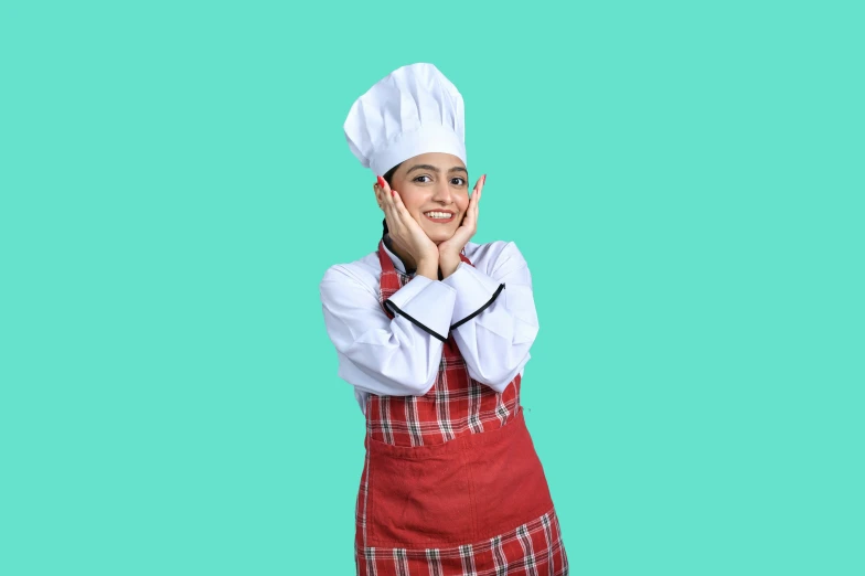 a woman wearing an apron and hat with her hands on her face