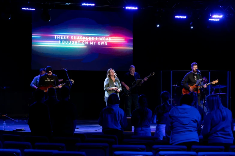 people on a stage are playing music with instruments