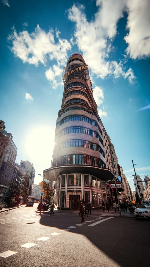 people stand in front of an elegant building on a sunny day