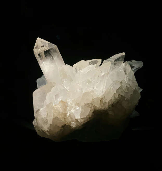 a crystal and rock on a black background