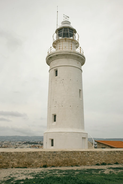 there is a large light house standing in a field