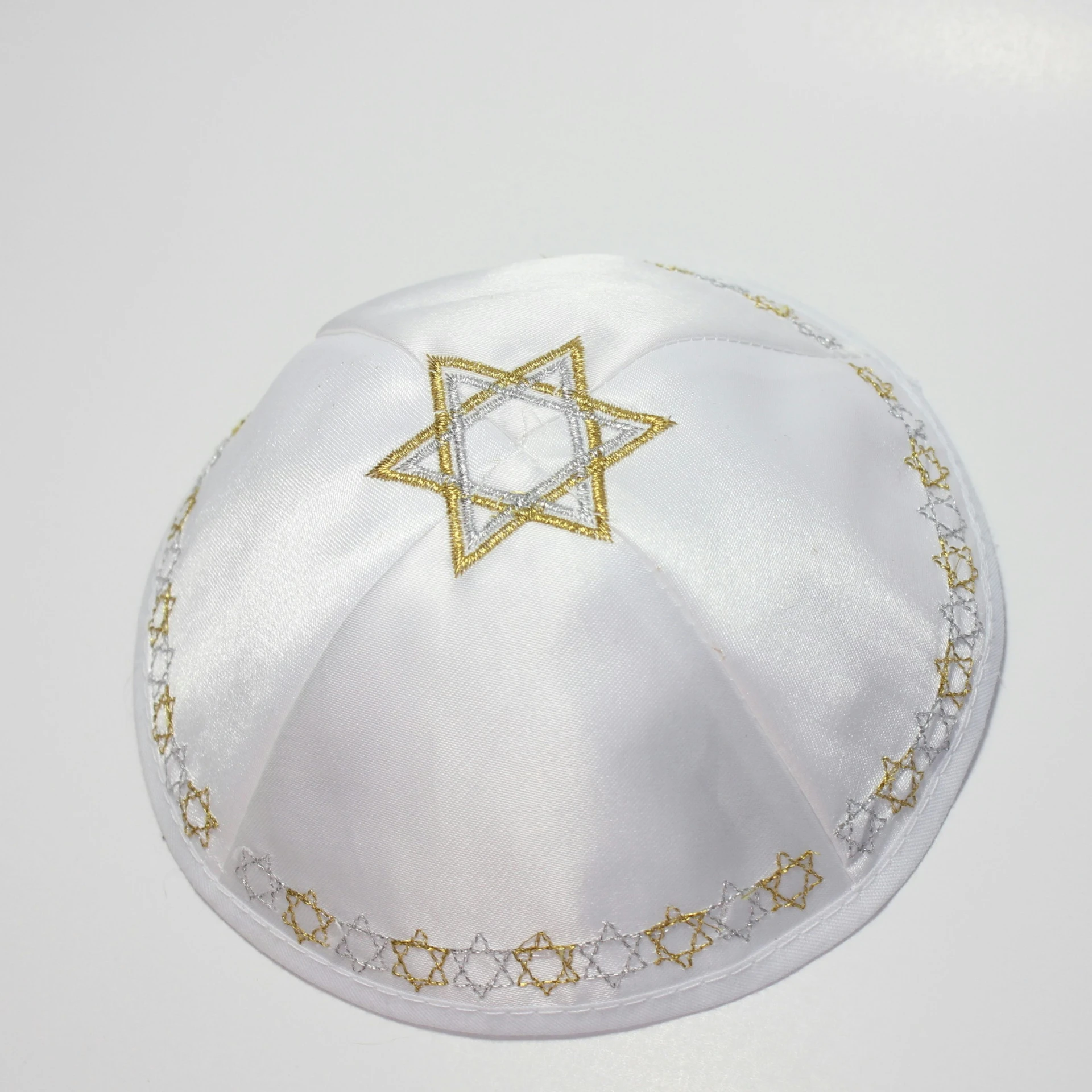 a white, silk, and gold jewish hat