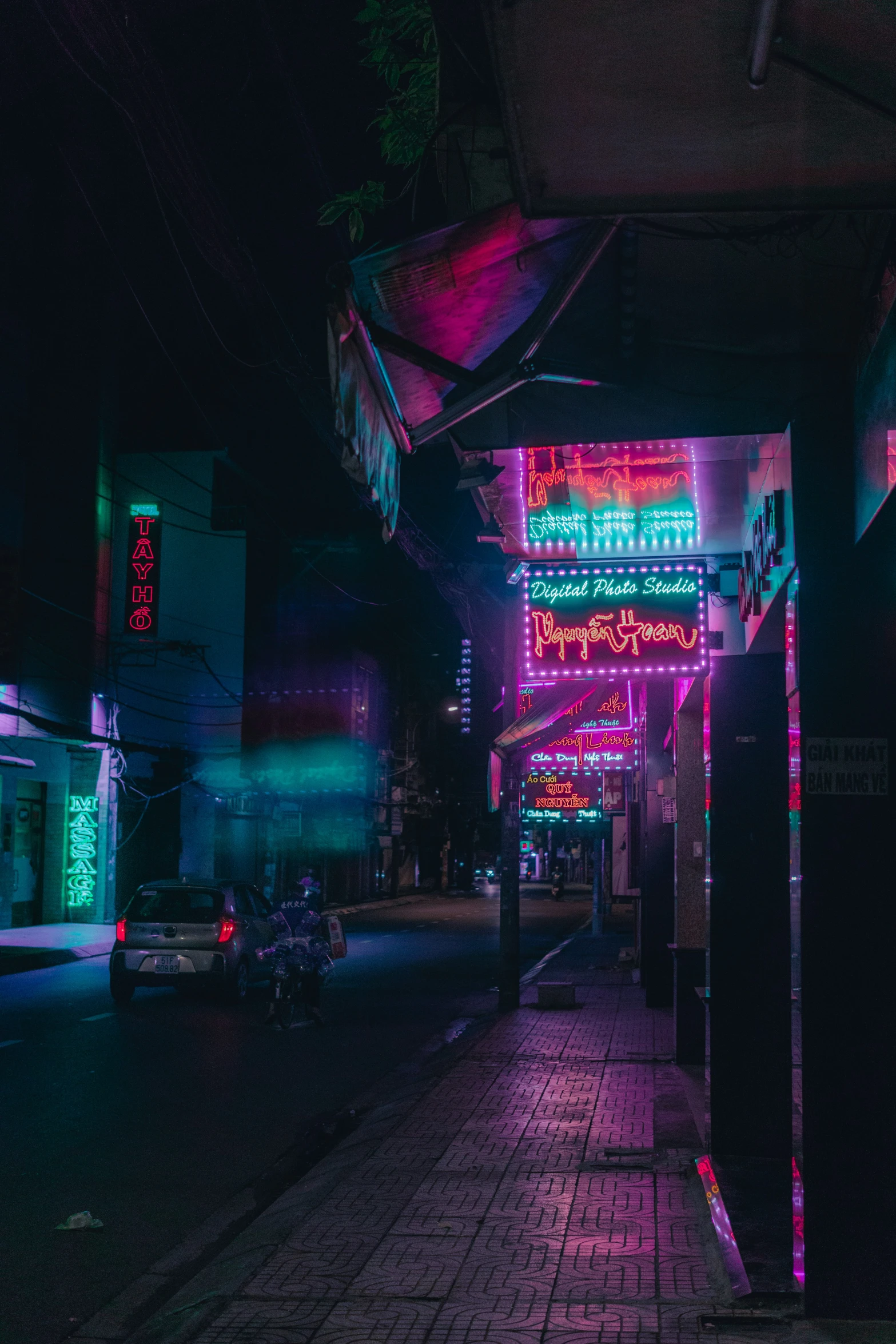 the sidewalk is empty with an umbrella at night