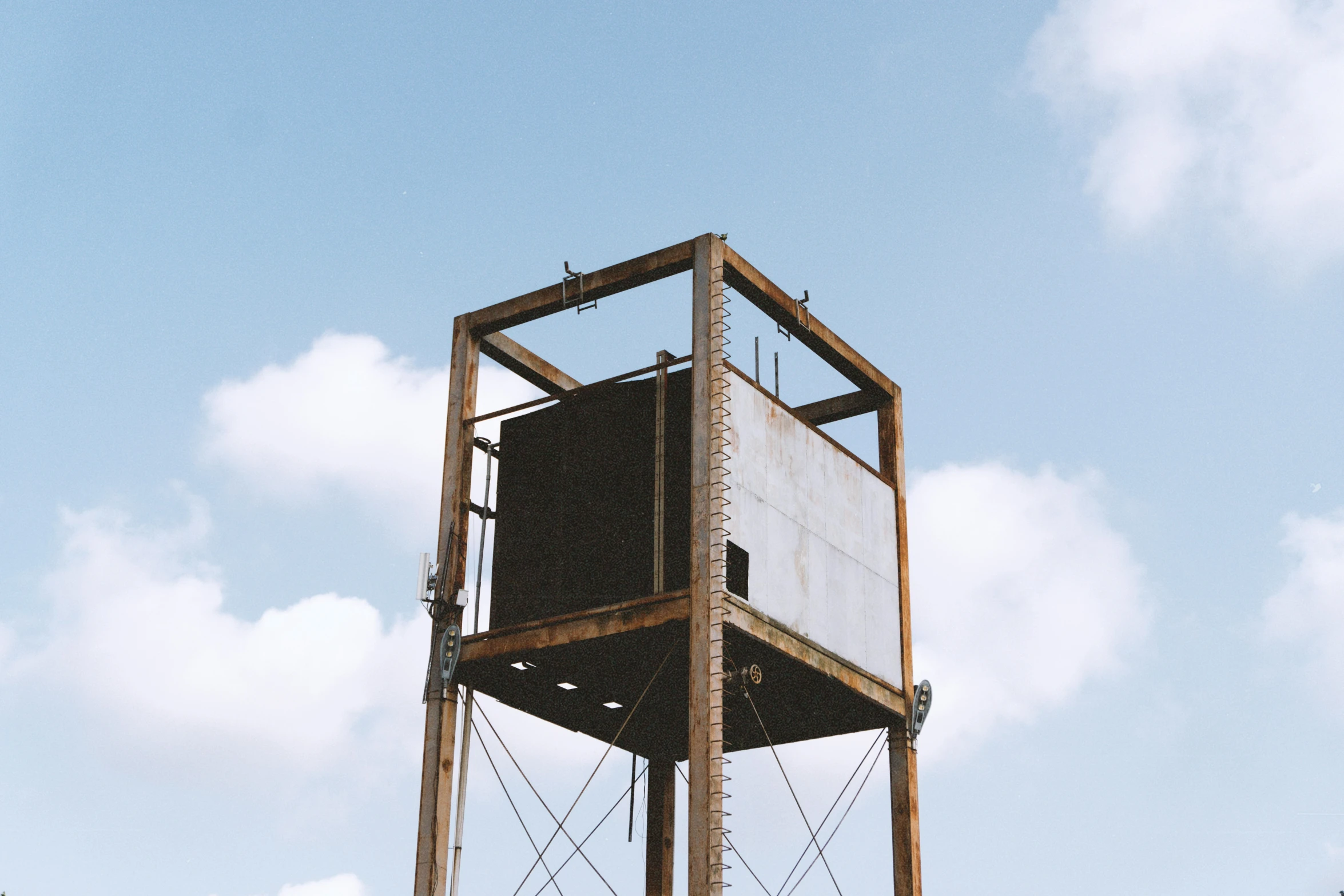 the old tower is surrounded by wood and metal