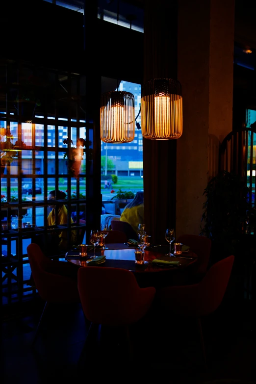 two tall light bulbs hang over an outdoor dining room