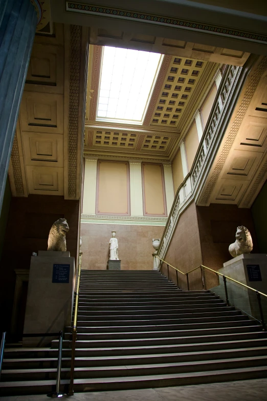 two statues sitting in the middle of stairs next to a stair case