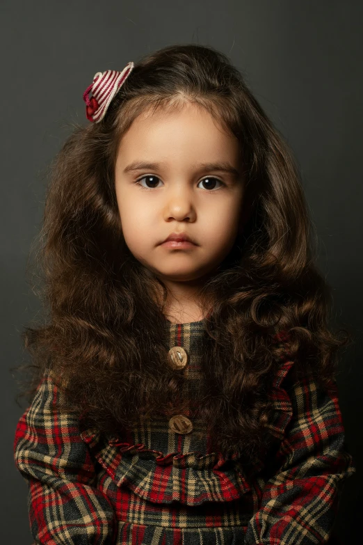 a little girl posing for a portrait in her pajamas