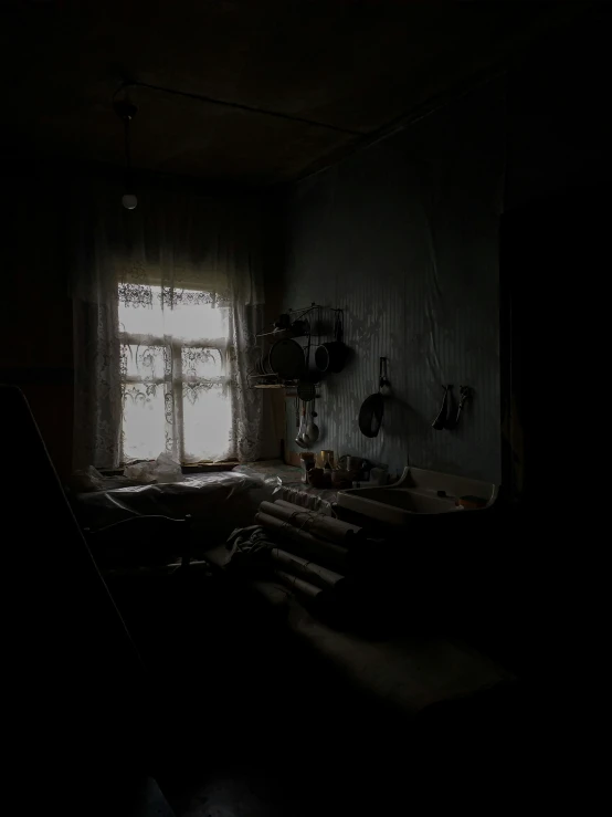 a dark room with a window and some curtains