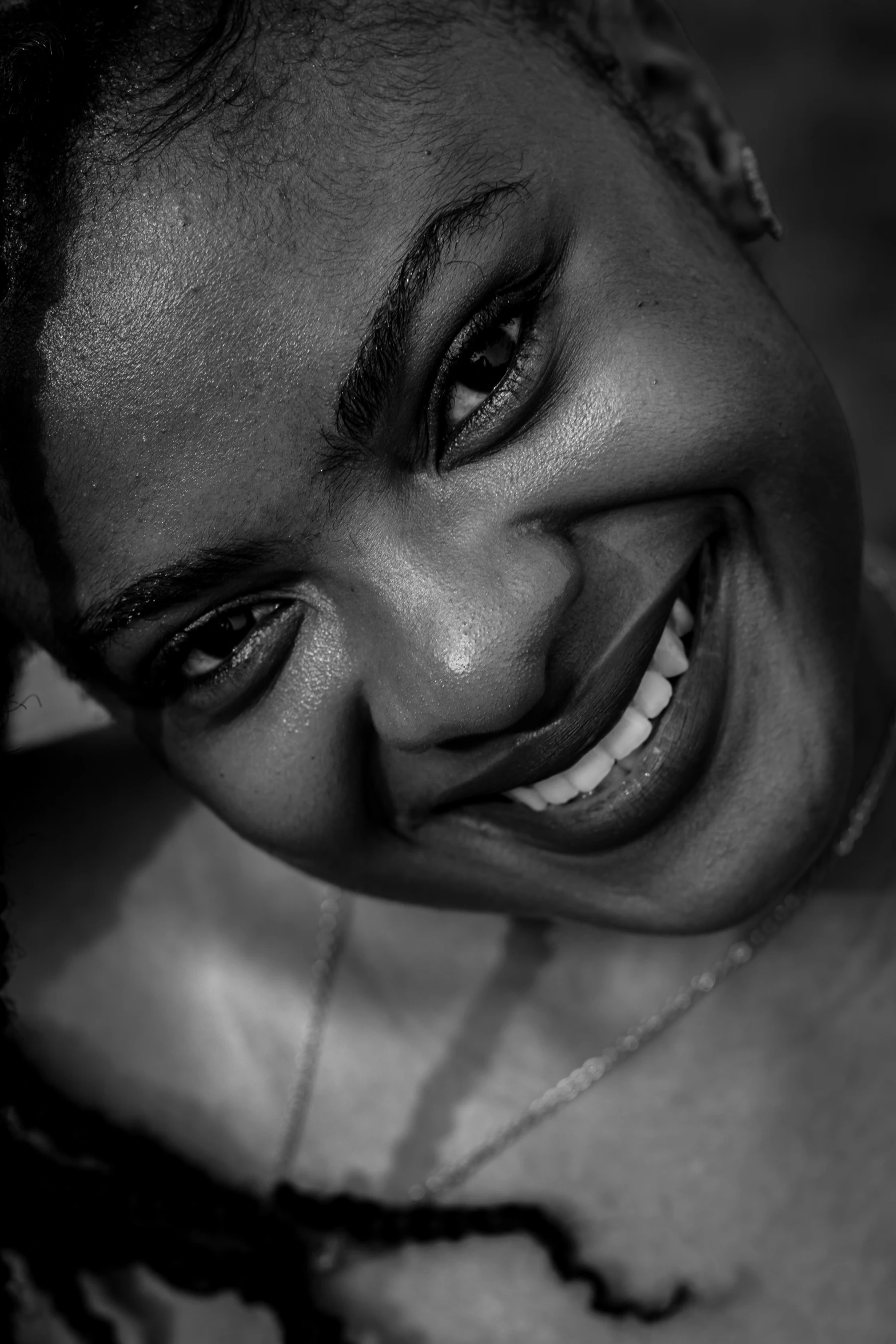 a smiling woman in black and white with dark ids