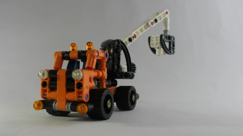 a toy truck is shown with wheels and a crane