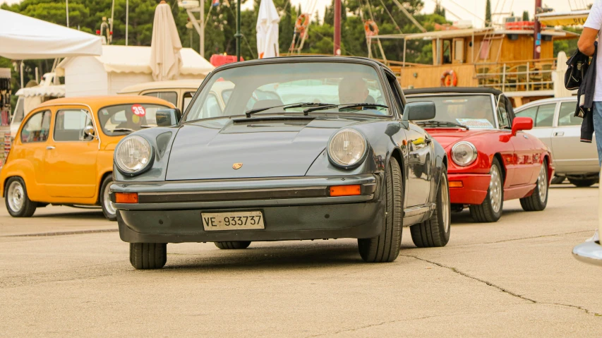 an image of a black car parked by some cars