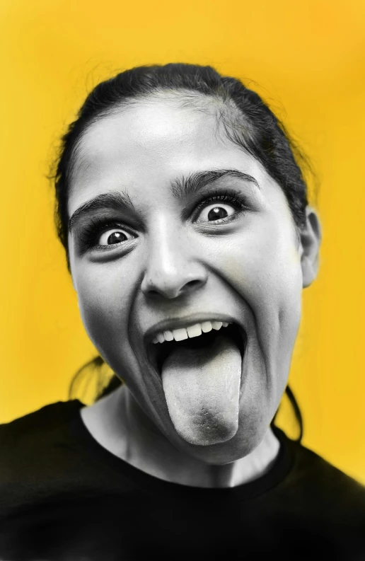 a girl making a funny face and showing off her tongue