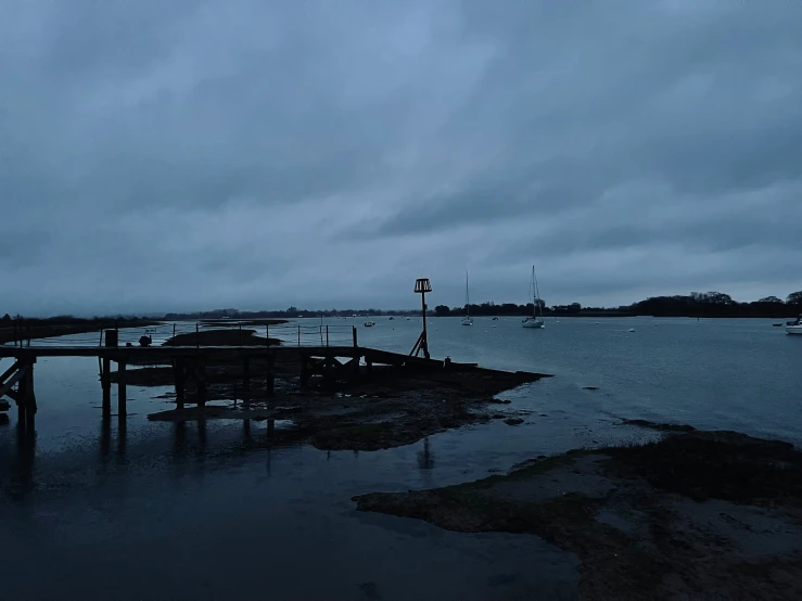 some docks are standing out in the water at night