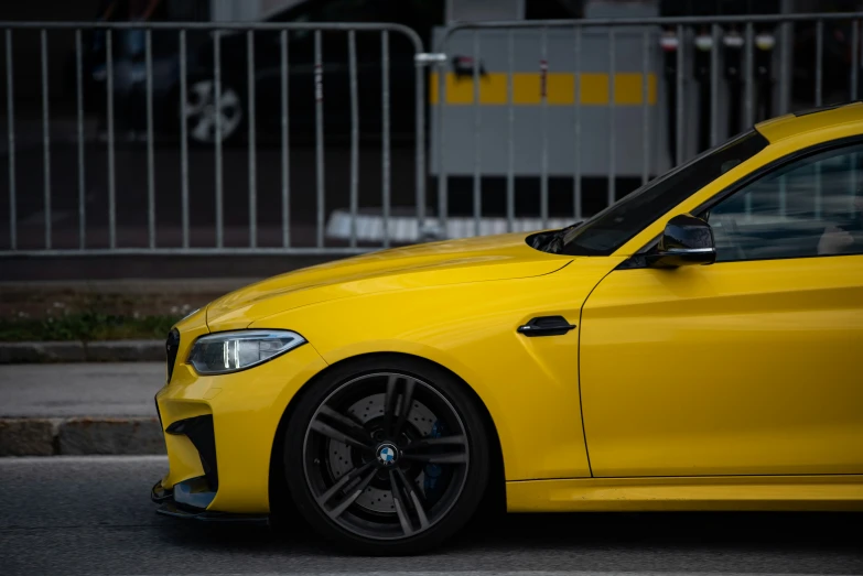 a bright yellow bmw vehicle parked on the street