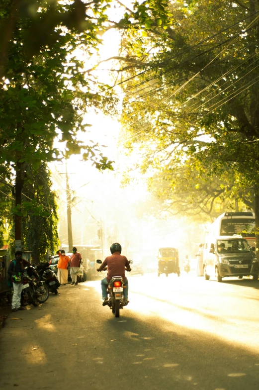 a person riding a motorcycle down the street