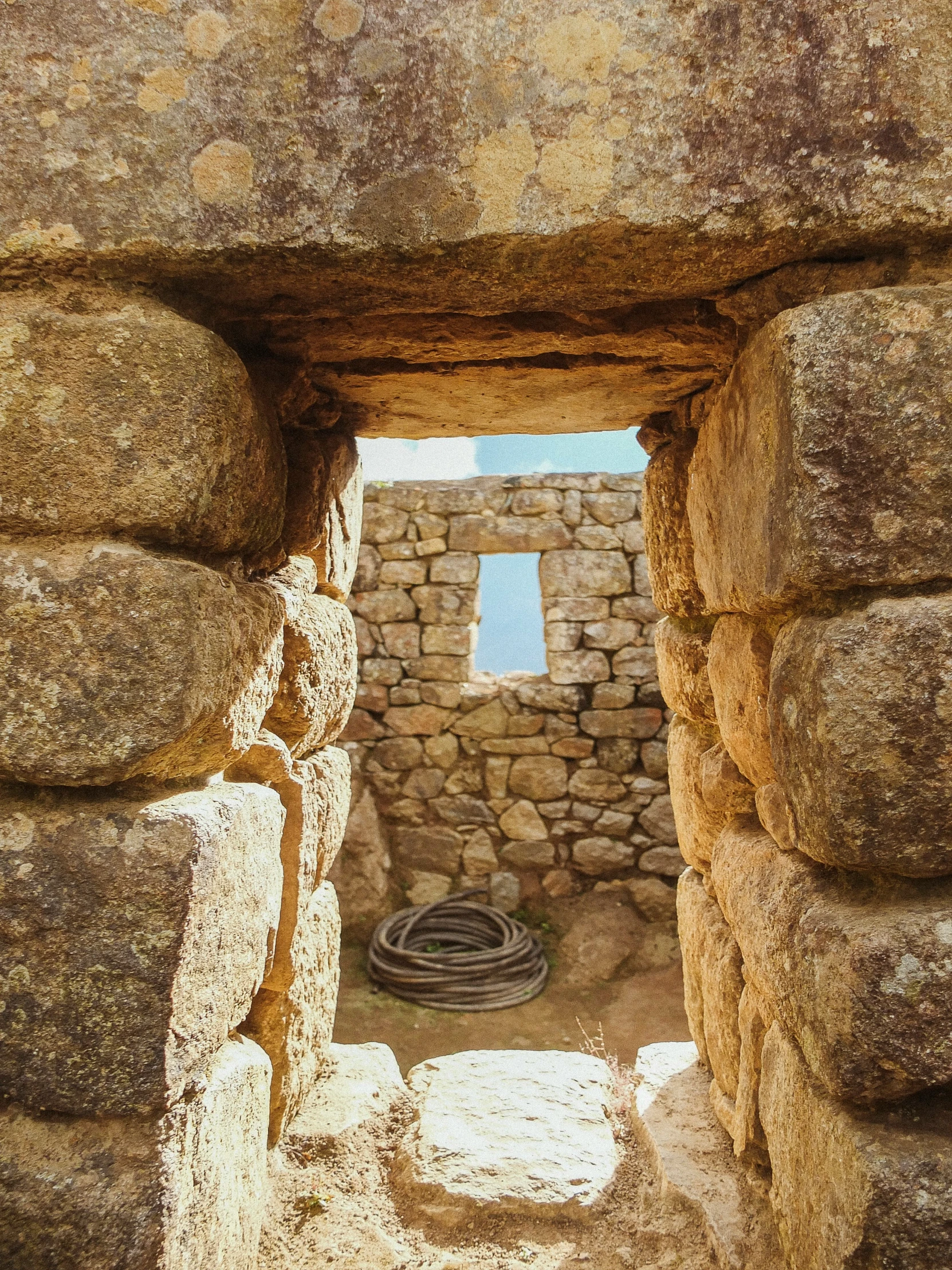 an image of stone building with water well