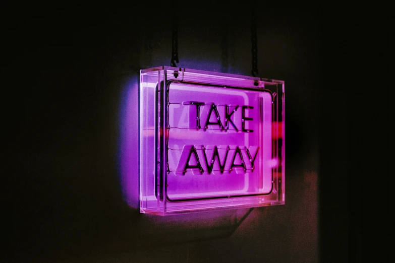 a purple sign that reads take away next to a wall