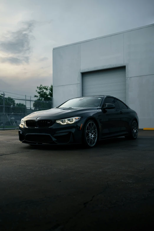 an automobile is parked in front of a garage