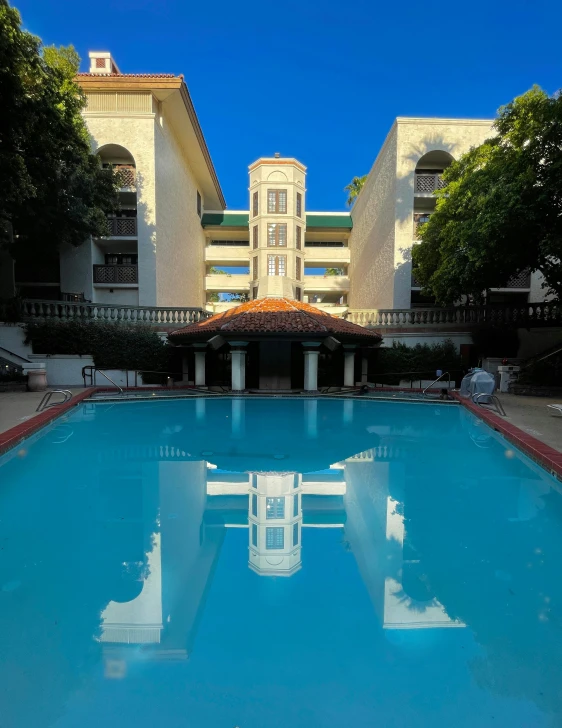 a very big pretty swimming pool with a clock on the building