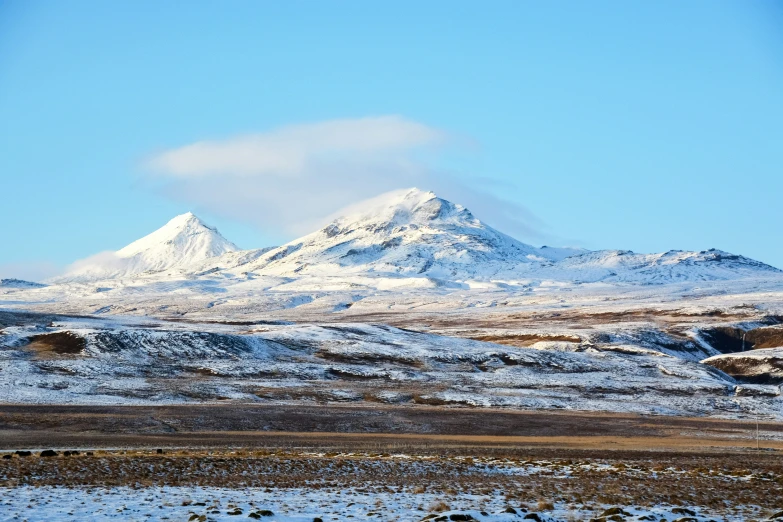 the snow covered mountains are standing against a blue sky