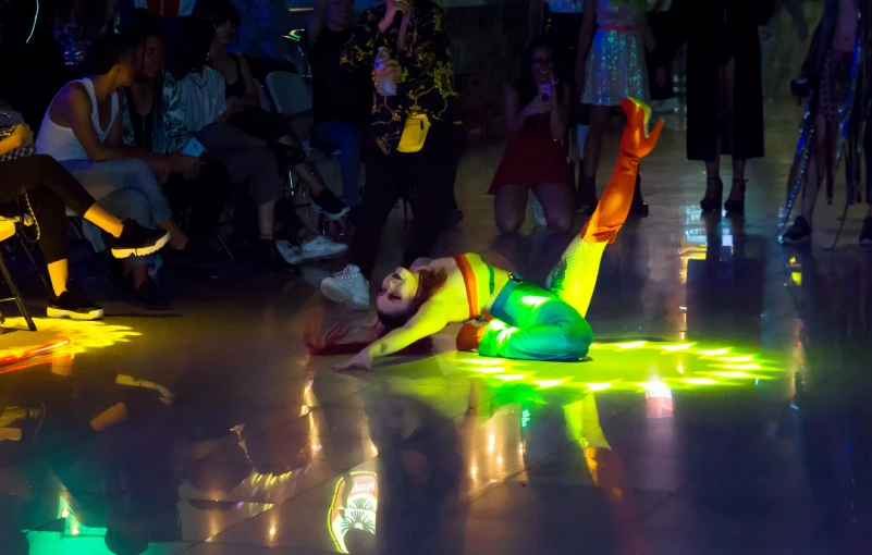 a person on the ground with their foot on a light up object