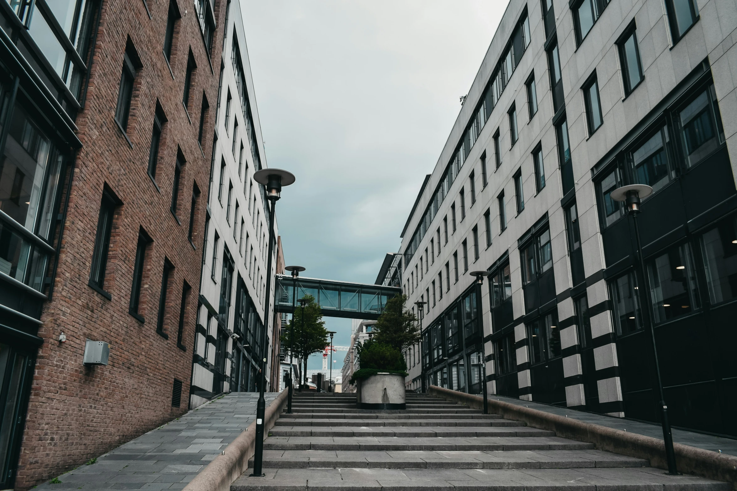 a stairway with windows and grey steps next to buildings