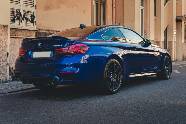 the rear end of a blue bmw car