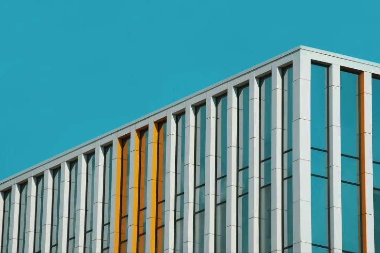 the side of a building has multicolored metal bars on it