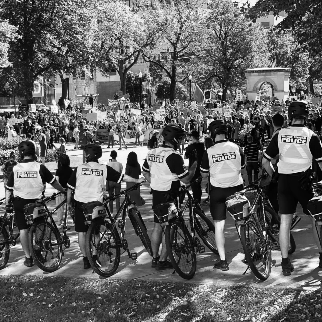 some police officers on bicycles in black and white