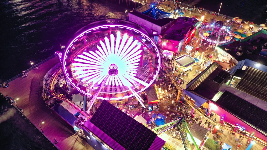 ferris wheel lit up purple in the dark sky