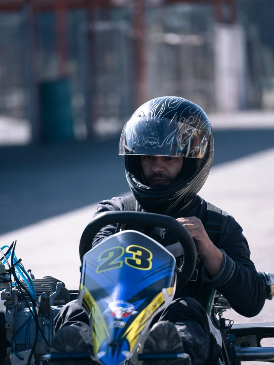 a man wearing a helmet drives a small motorcycle