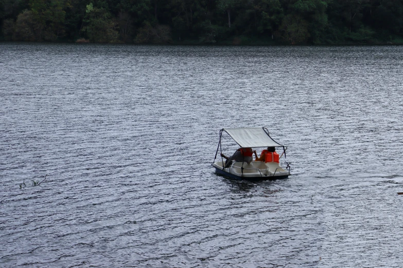 a white boat floats through a calm lake