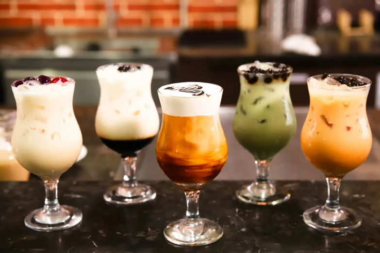 four different kinds of drinks sit in a row