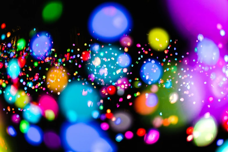 blurry image of a colorful background in blue, pink, yellow and green