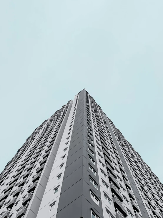 looking up at a tall building's balconies