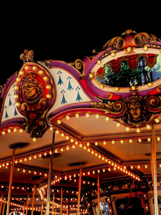 there is an elaborately decorated carnival ride at night