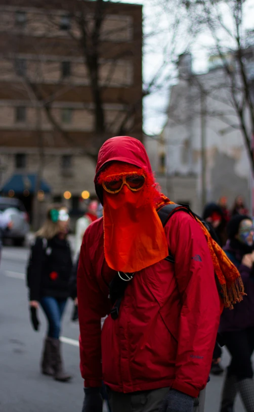 a person with a red mask and goggles walking