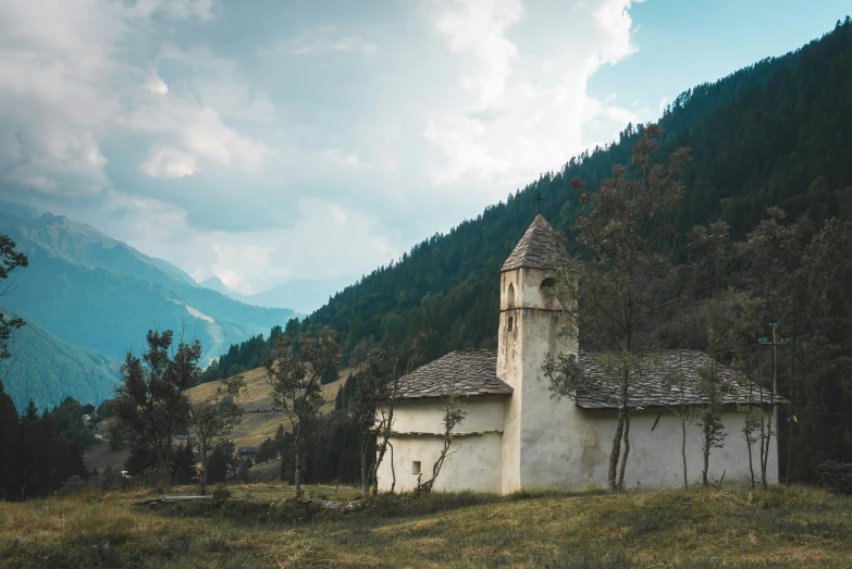 a old house in the mountains with trees