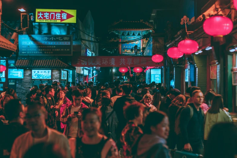 a large crowd of people walk on the street